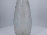 a glass vase sitting on a table with a white background