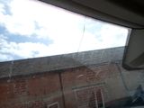 a view of a brick building through a car window