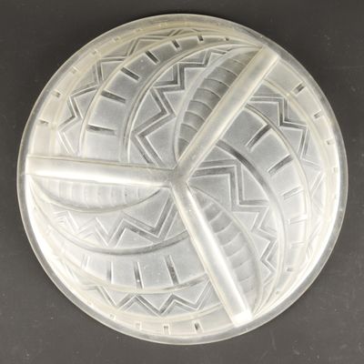 a silver plate with a design on it on a table