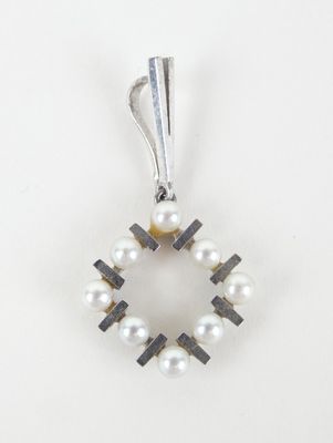 un pendentif en forme de croix, composé d'une perle blanche et d'argent, sur fond blanc