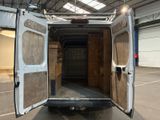 a white van with its doors open in a building