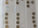 a lot of coins in a plastic container on a table