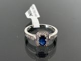 a picture of a ring with a sapphire and diamonds on it