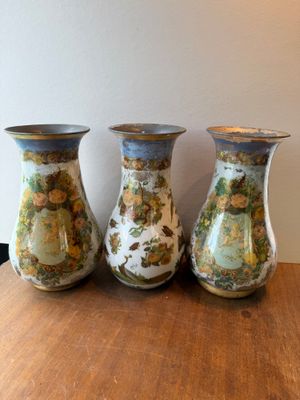 three vases that are sitting on a table
