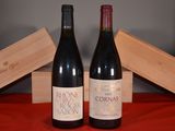 two bottles of wine sitting next to each other on a table