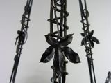 a metal hanging basket with fruit inside of it
