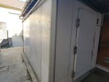 an image of a garage with a door and a door on the side of the building