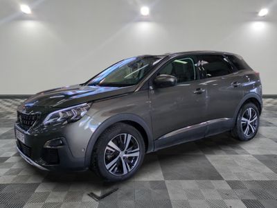 the grey car is parked on a checkered floor in a garage