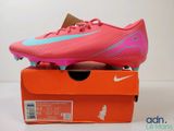 a close up of a pair of pink soccer shoes on a box