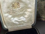 a small case with a gold coin inside of it