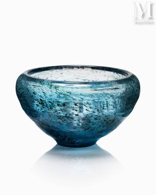 a blue glass bowl that is sitting on a table