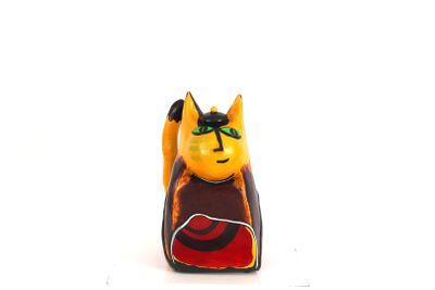 a small figurine of a cat sitting on a table