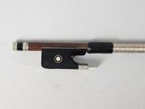 a close up of a violin bow on a white surface