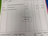 a picture of a receipt on a table with a calculator next to it
