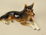 a figurine of a dog laying down on a table