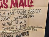 a poster on the wall of a movie theater