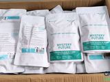 five bags of mystery future coffee in a cardboard box
