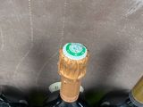 four bottles of wine are lined up in a row in front of a box