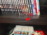 a lot of dvds on the shelf in the room