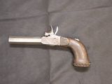 an old gun that is sitting on a piece of cloth