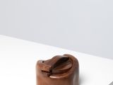 an image of a small wooden object on a white surface