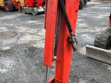 a red excavator that is sitting in the dirt