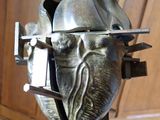 a metal sculpture of a man ' s head on a stand
