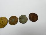 quatre types de pièces différents posés sur une surface blanche