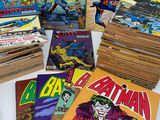 a lot of comic books that are on the table