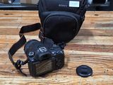 a camera and a bag on the floor next to a camera
