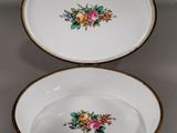 pair of porcelain bowls with floral designs on them on a table