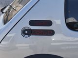 a close up of a car ' s tail light with a clock on it