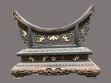a very ornate bench that is on display on a gray background