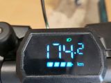 a digital clock on the handlebar of a bike