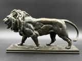 an image of a bronze statue of a lion on a marble base