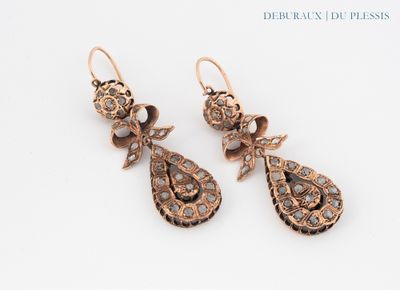 an image of a pair of earrings on a white surface