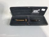 un étui noir contenant un stylo, posé sur une table