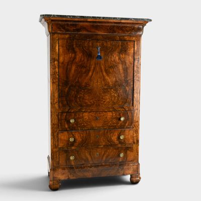 an image of a small chest of drawers with a clock on top
