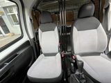 two seats in the back of a truck with a steering wheel