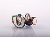 a small figurine of a man and a woman sitting on top of an apple
