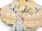 a small figurine of a woman sitting on a table