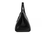 a black crocodile skin handbag on a white background