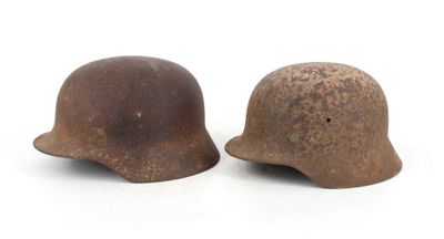 pair of old rusty helmets on white background with copy space for text