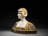 a white marble bust of a woman wearing a gold dress