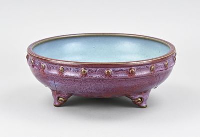 purple and blue ceramic bowl on stand on white background