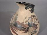 a vase with a picture of a woman and a bird on it