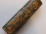 a green case with gold designs on it on a white surface