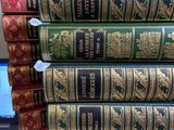 many books stacked on top of each other on a desk