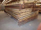 a large pile of steel bars stacked up in a warehouse