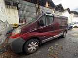 an image of a maroon van parked in front of a building